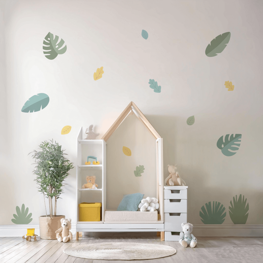 Children's room with a white house-shaped bed, shelves, and toys against a wall with plant leaf decals.